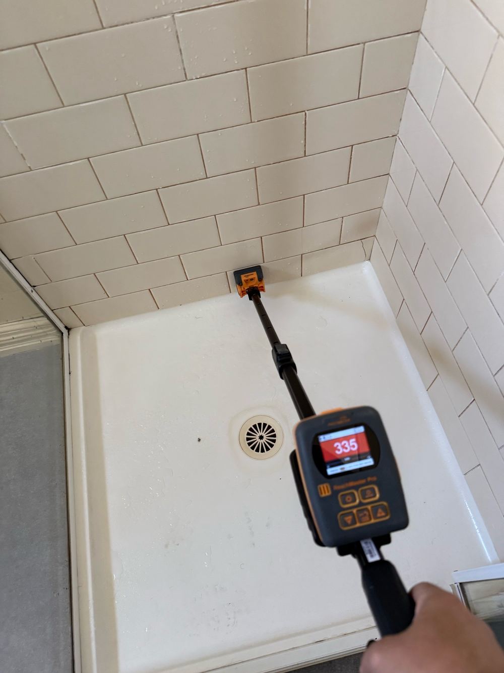 Elevated moisture detected behind the shower tiles, found during a building and pest inspection in Newport