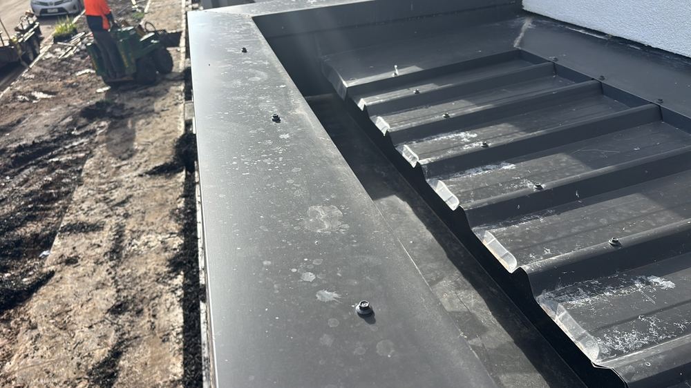Roof cappings screwed through the top, where fixings belong in the sides, found during a pre-handover inspection in Mambourin