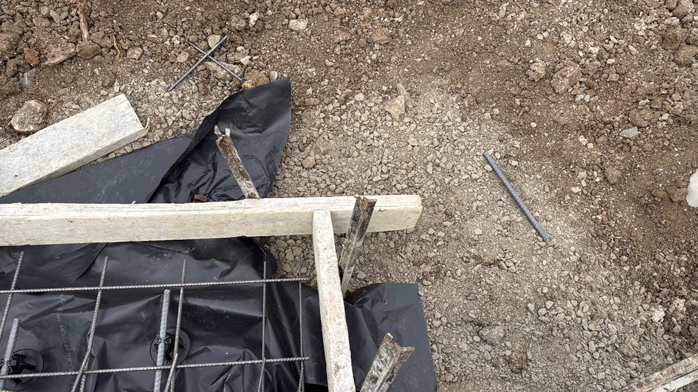 Vapour barrier stopping short of the edge beams, leaving a path for ground moisture, found during a slab pre-pour inspection in Mambourin